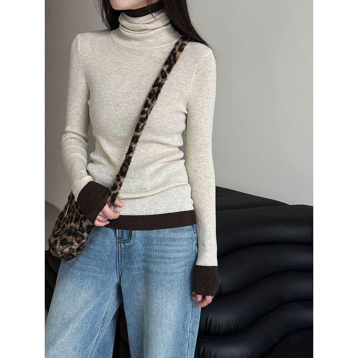 Women's knit pullover with stand-up collar and contrast details