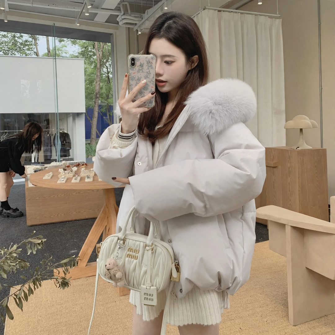 Short, padded women's jacket with hood and fur collar