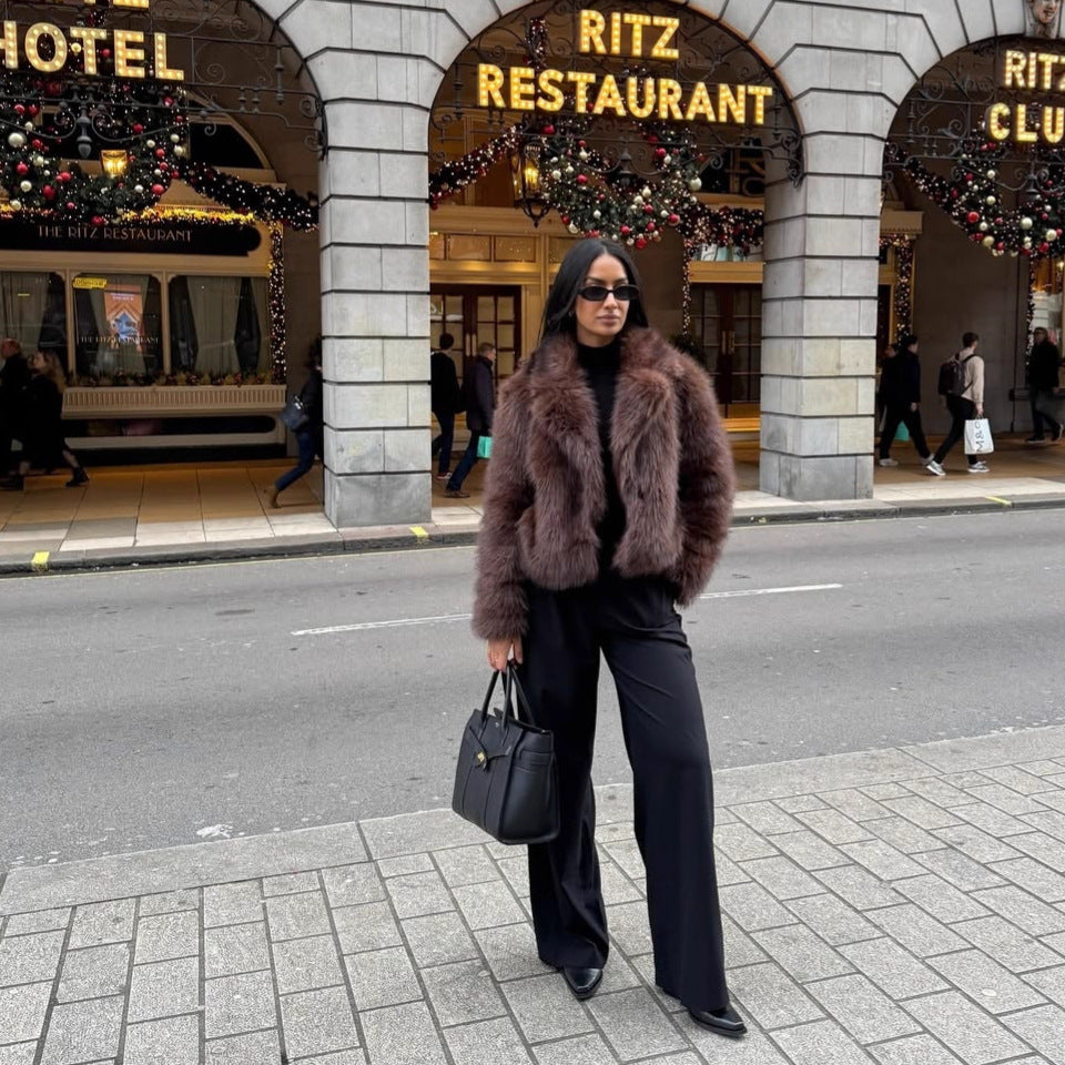Fashionable women's faux fur coat in coffee brown