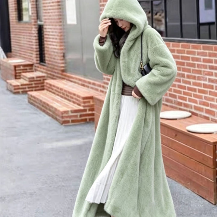 Long women's coat made of faux fur with hood