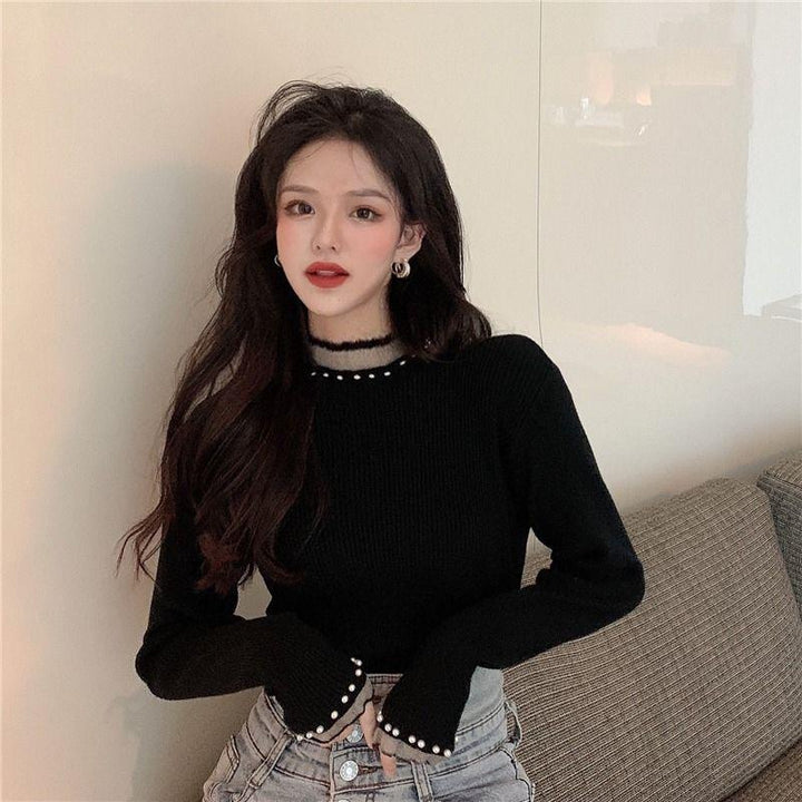 Women's knitted pullover with stand collar and pearl details