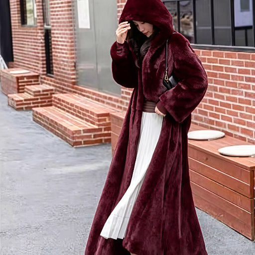 Long women's coat made of faux fur with hood
