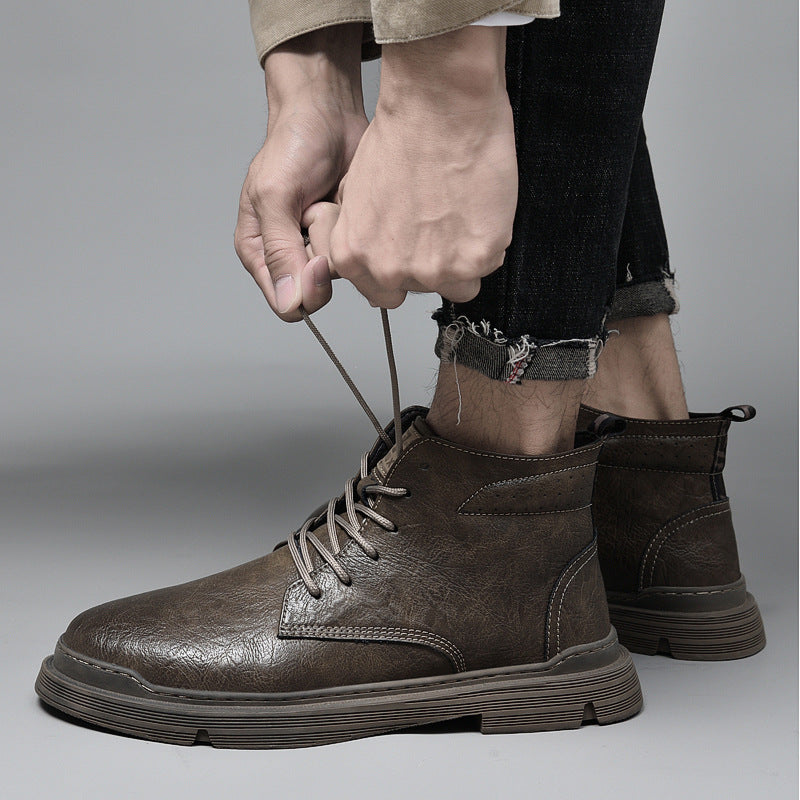 Padded men's leather boots with decorative stitching
