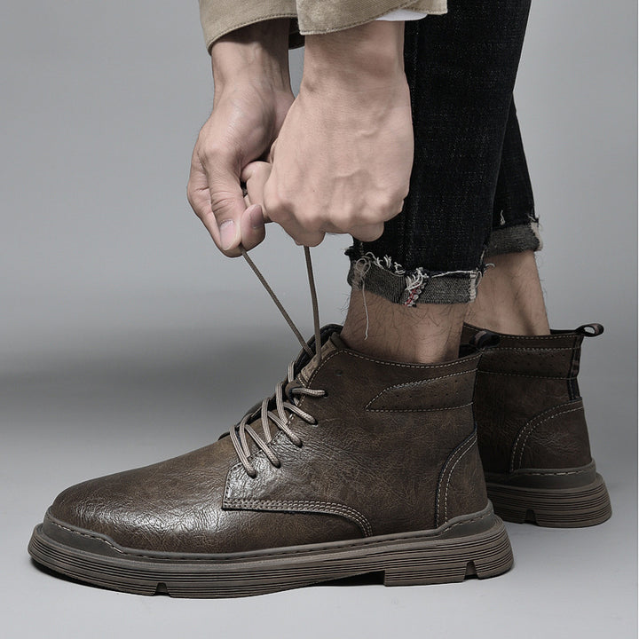 Padded men's leather boots with decorative stitching