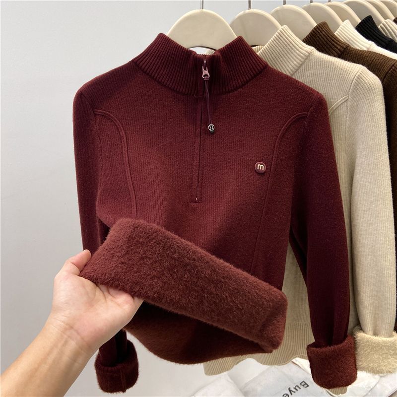 Padded women's knitted sweater with zipper and stand-up collar