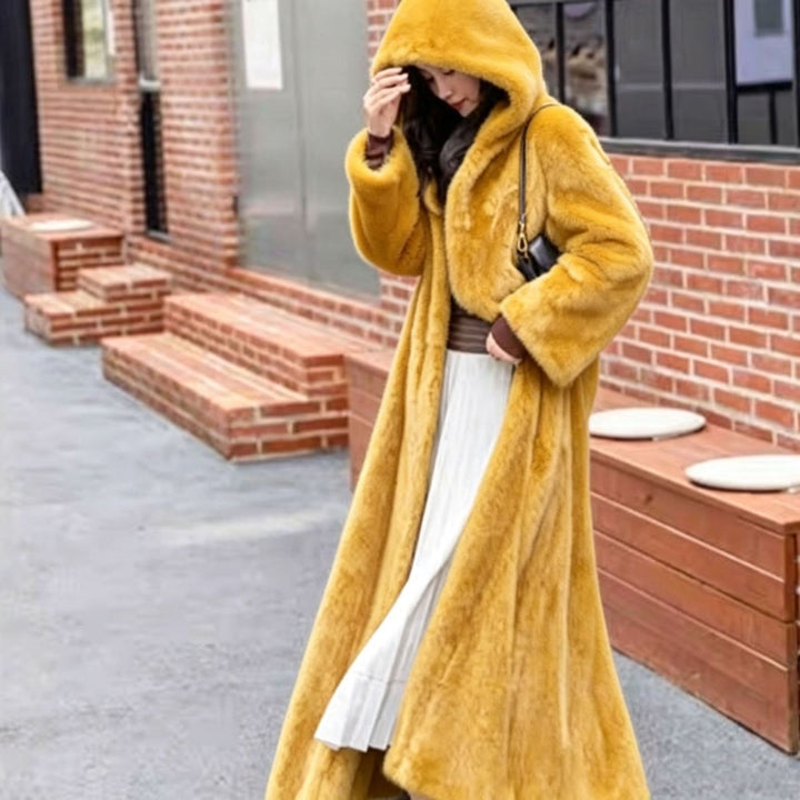 Long women's coat made of faux fur with hood