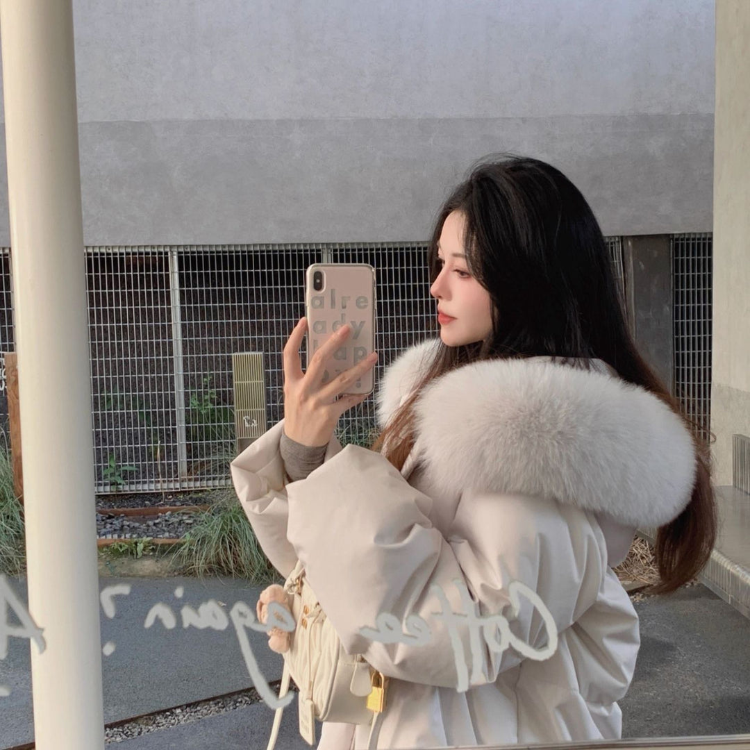 Short, padded women's jacket with hood and fur collar
