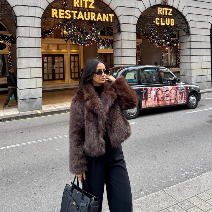 Fashionable women's faux fur coat in coffee brown