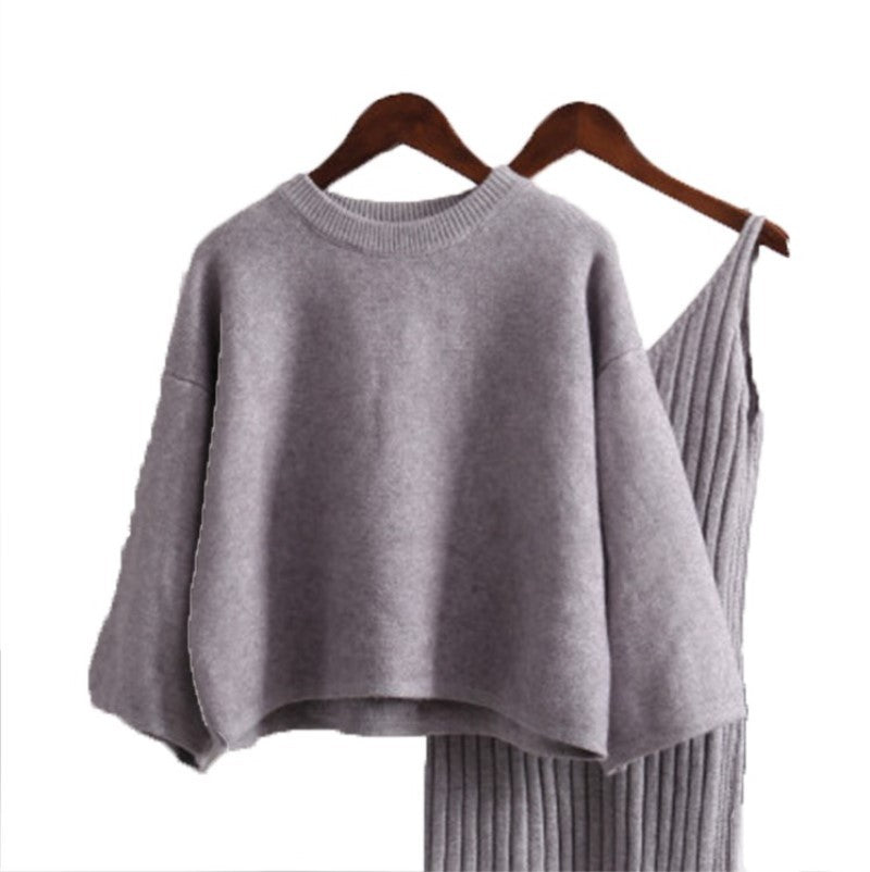 Women’s fashionable knitted set with a comfortable oversized sweater and a chic fitted dress.
