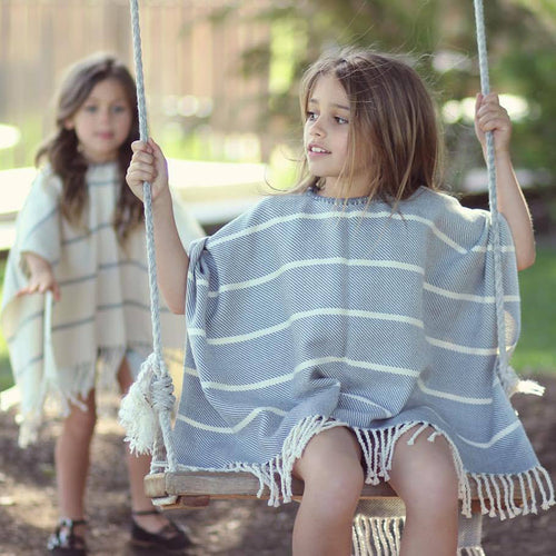 Women's beach poncho with fringed hem and striped design
