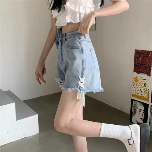 Ladies' denim shorts with trendy destroyed details and handcrafted accents
