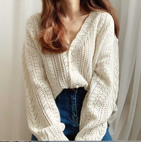 Thick knitted sweater for women with a trendy V-neck and chic button details