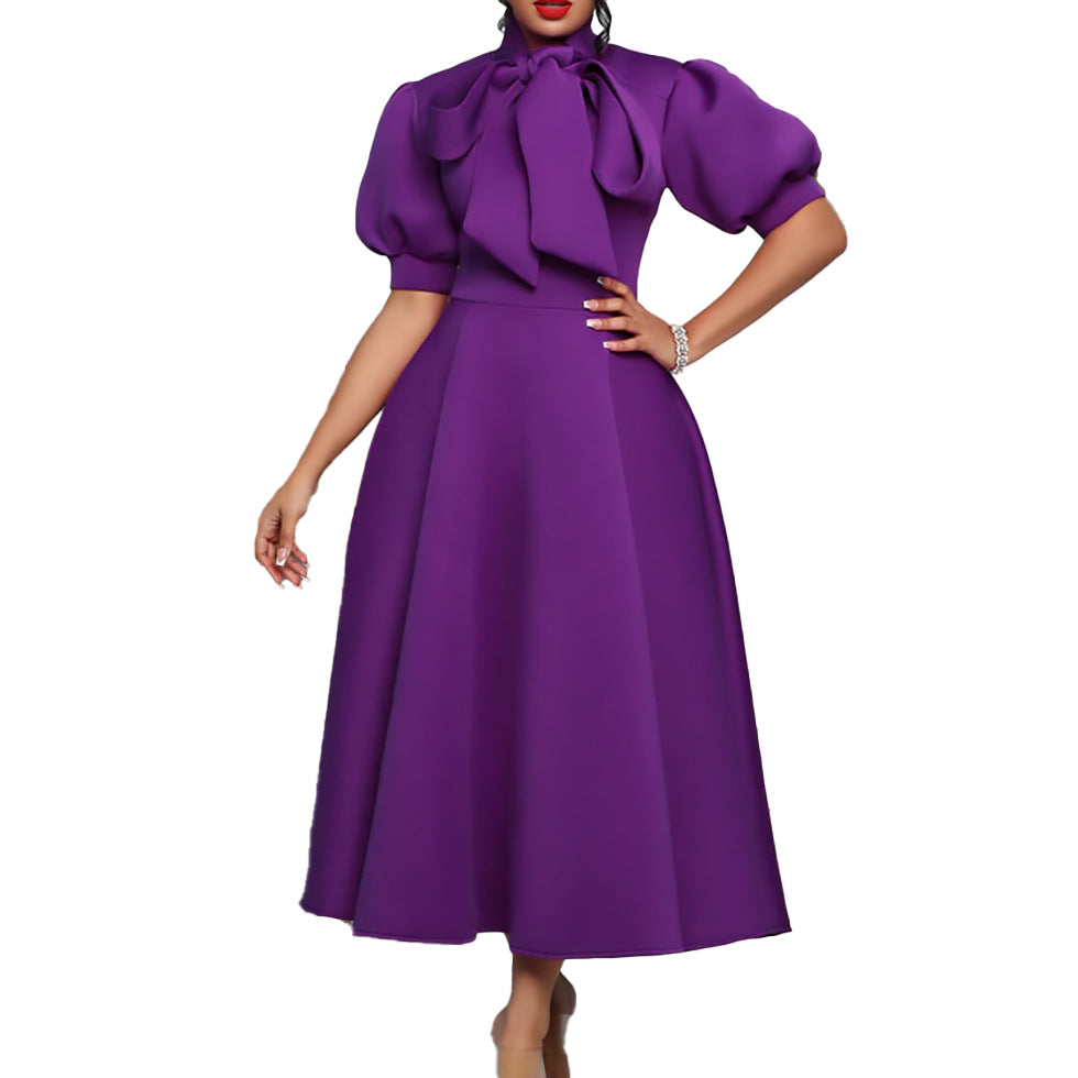 Elegant maxi dress for women with voluminous puff sleeves and a bow neckline Lune London