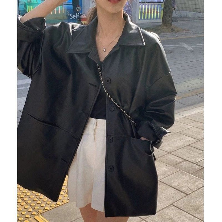 Women's fashionable leather jacket in oversized style with classic collar and decorative buttons Chic & Stil