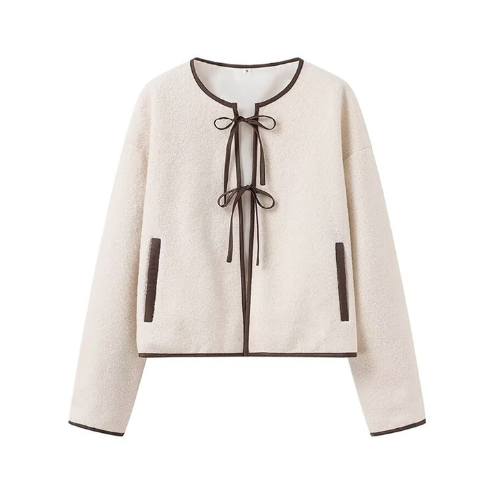 Fashion women's transitional jacket with decorative drawstring and side pockets.