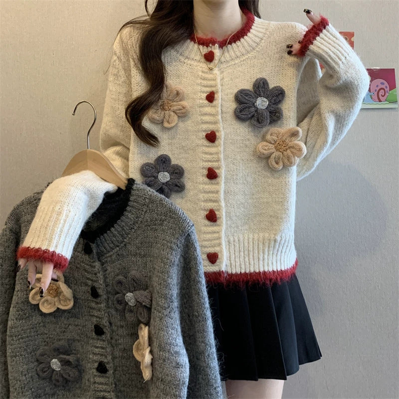 Ladies playful pullover with heart-shaped button closure and floral appliqués Lune London