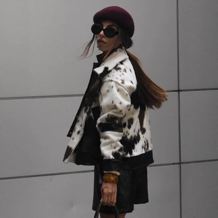 Women short padded biker jacket made of faux fur in cow print with contrast leather trim Amarae