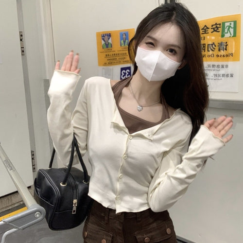 Women's long-sleeved crop top with button closure and elegant design