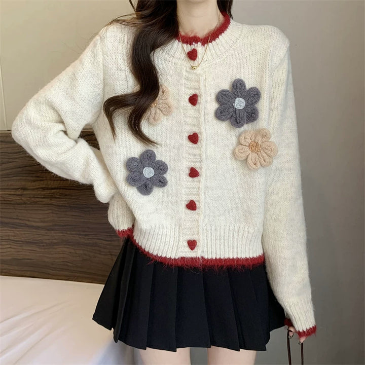 Ladies playful pullover with heart-shaped button closure and floral appliqués Lune London