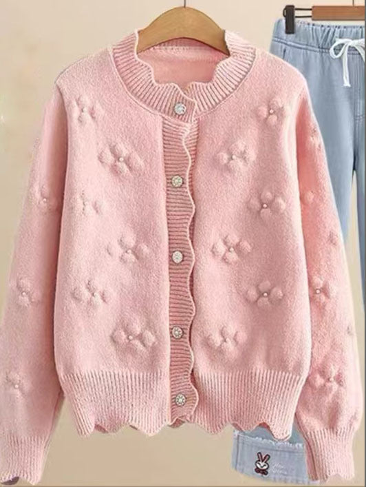 Ladies playful knit vest with decorative pearl buttons and floral design Lune London