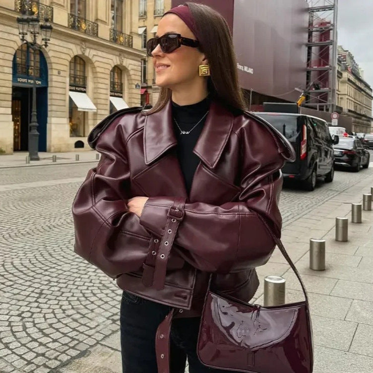 Faux leather biker jacket for women with a trendy cropped design, adjustable belt, and decorative buttons Lune London