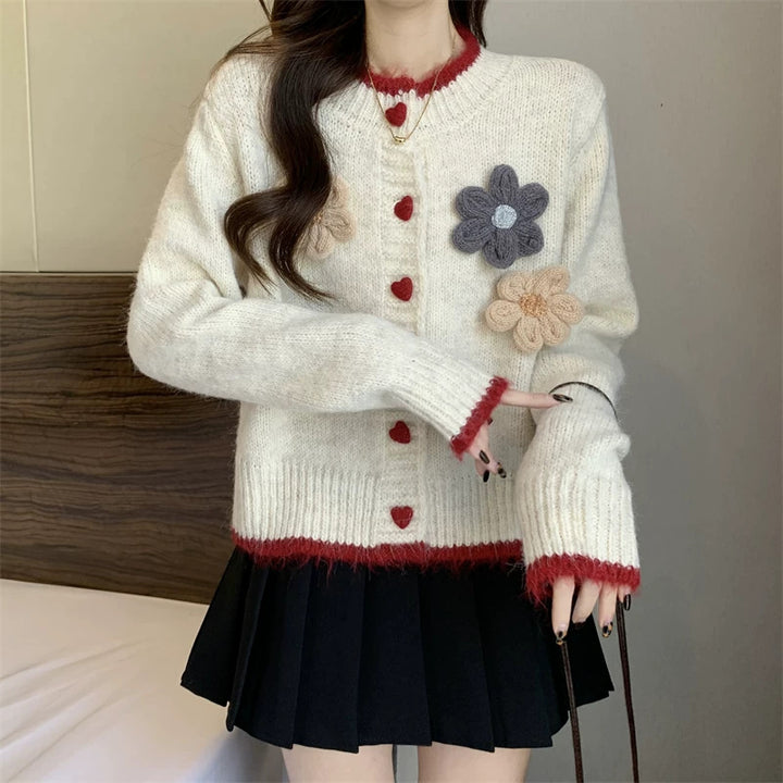 Ladies playful pullover with heart-shaped button closure and floral appliqués Lune London