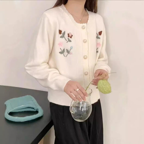 Women’s playful knitted vest with raised floral pattern and elegant pearl buttons Amarae