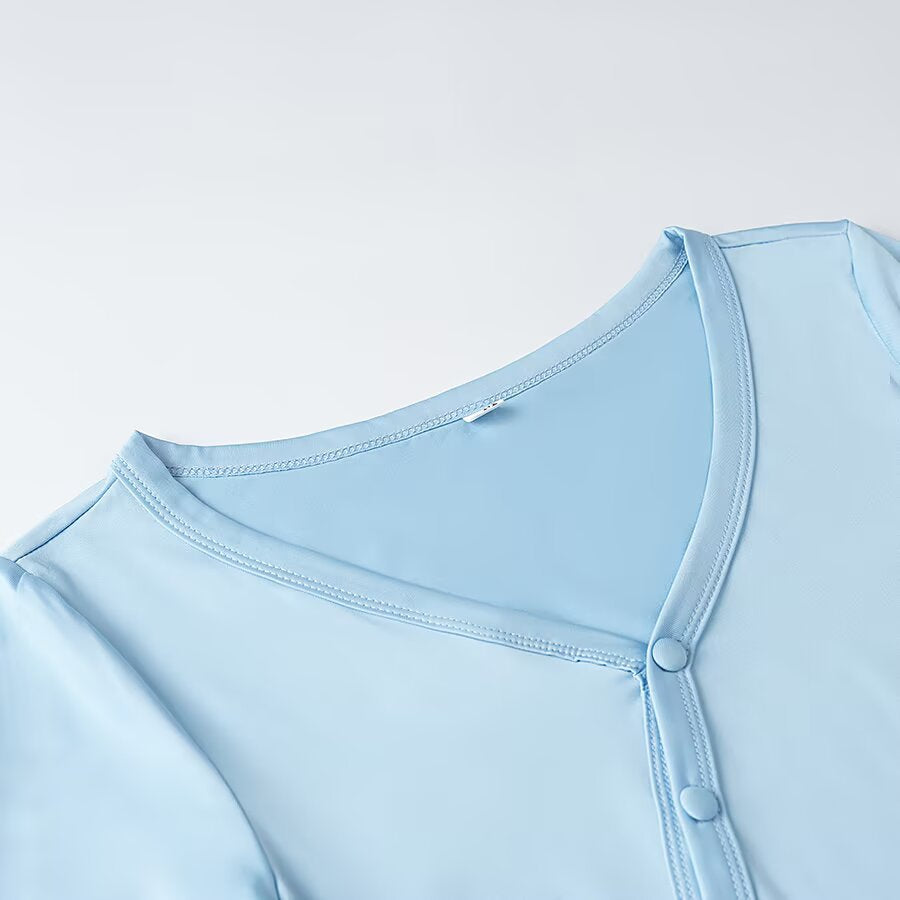 Women's wrap blouse with asymmetrical button placket, gathered hem, and trumpet sleeves Amarae