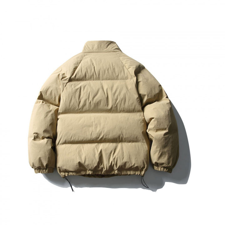 Unisex Boxy padded stand collar puffer jacket with drawstring hem and flap pockets Amarae