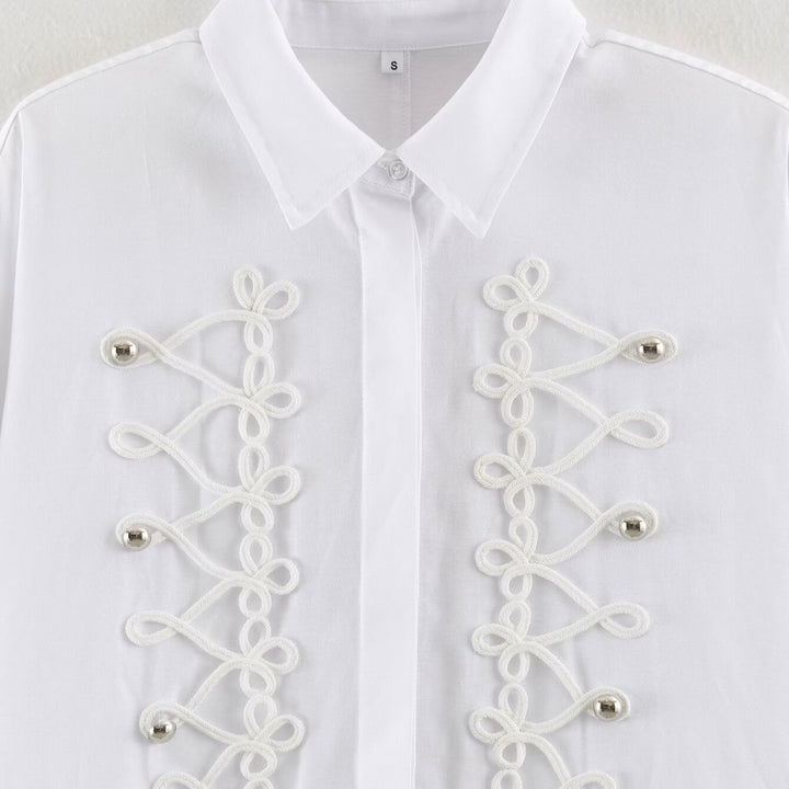 Women's blouse with long sleeves and decorative frog jewelry as well as concealed button placket