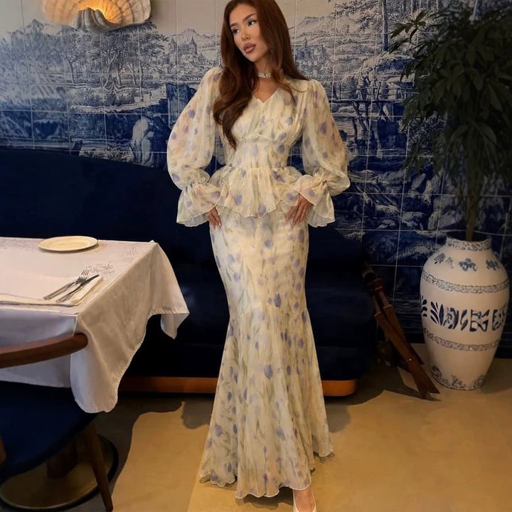 Women's dress made of transparent chiffon with fitted bodice, ruffled peplum and voluminous bell sleeves Amarae