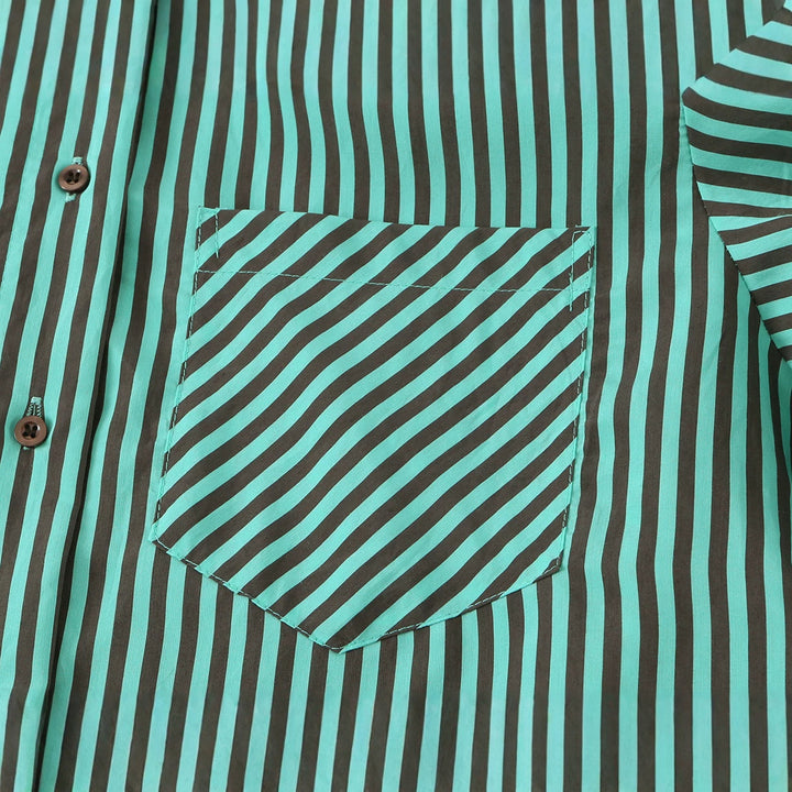 Women's oversized shirt blouse with diagonal stripe pattern, breast pocket, and asymmetrical hem.