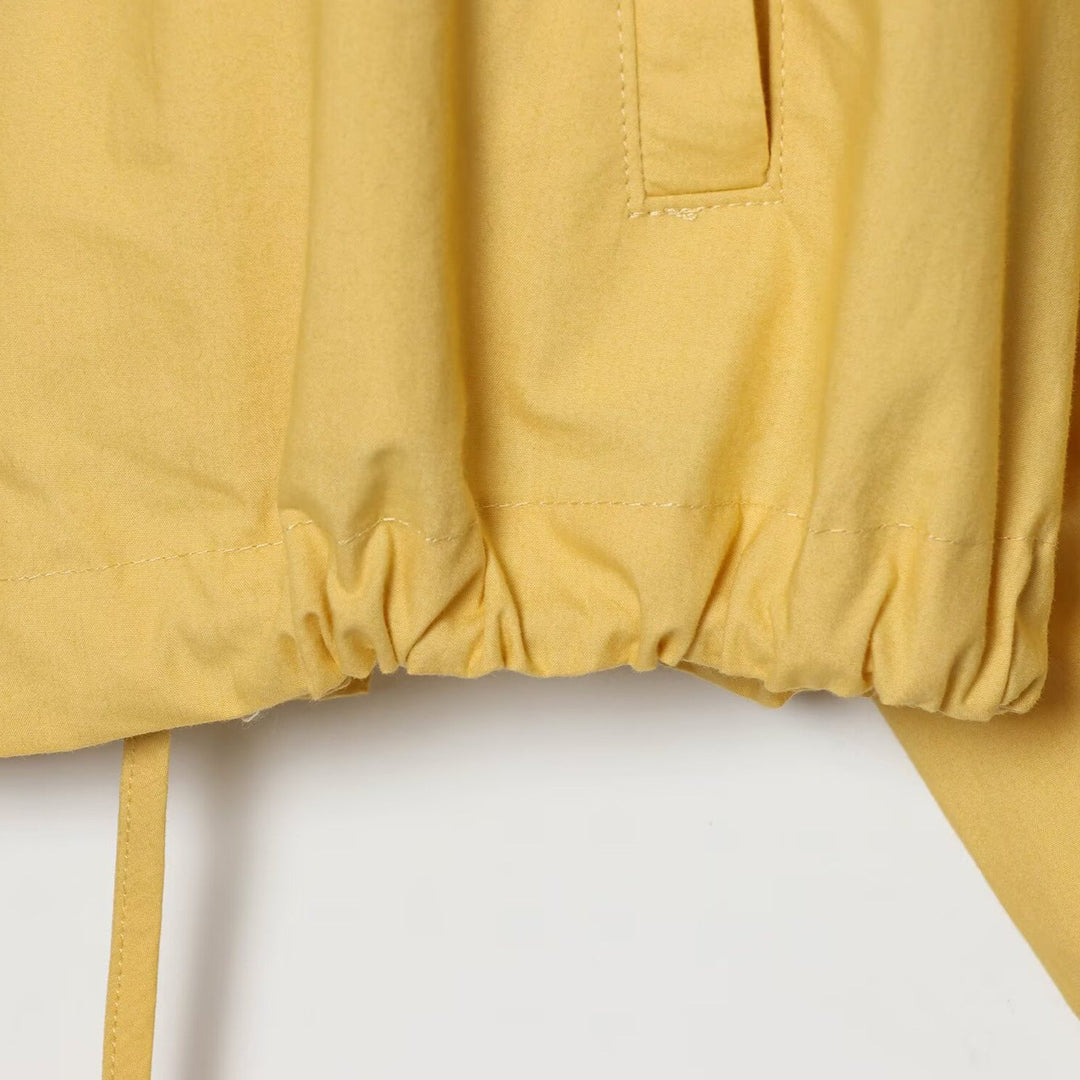 Women's short water-repellent transitional jacket with wide raglan sleeves and drawstring hood