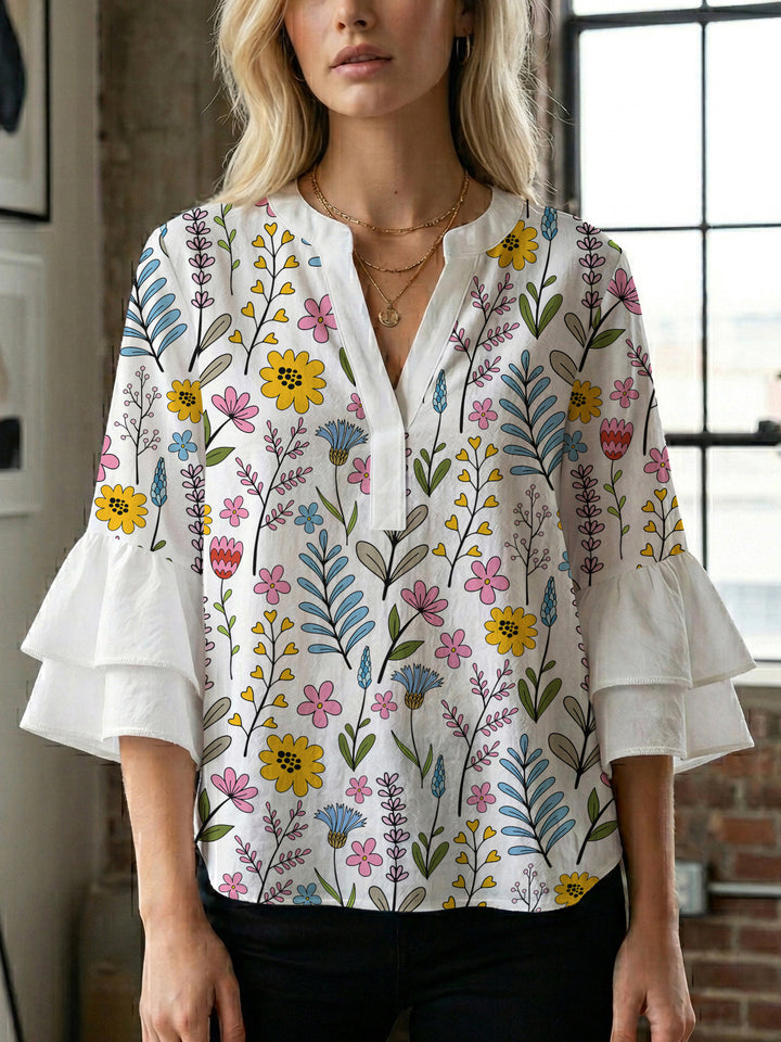 Women’s blouse with voluminous ruffled sleeves and floral pattern Lune London