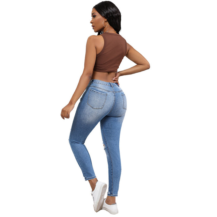 High-waisted women’s jeans with a trendy ripped look featuring strong tear details Lune London