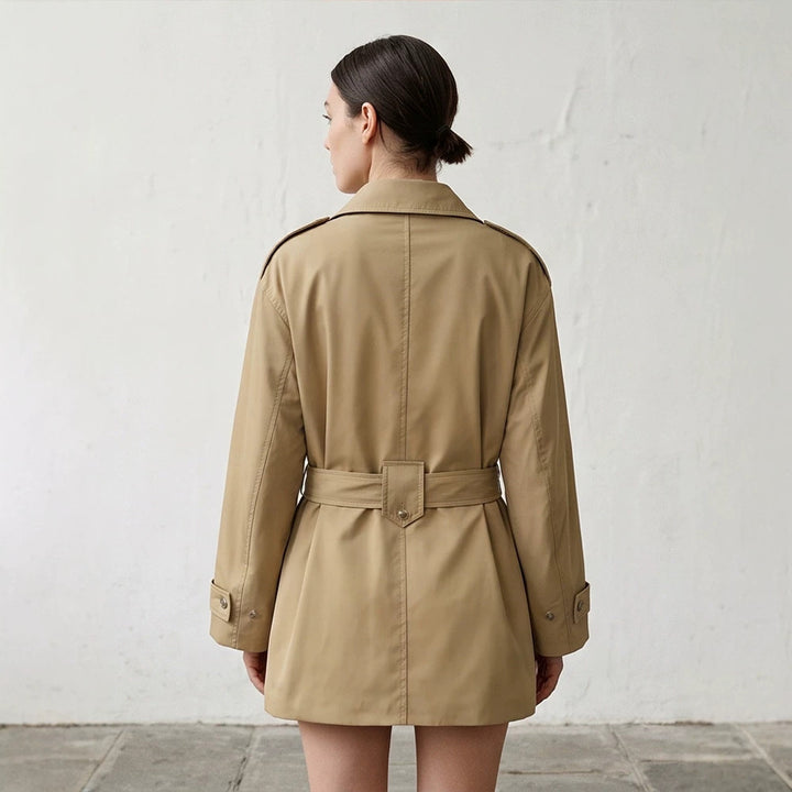 Women's short trench coat with waist belt, shoulder flaps, and adjustable cuffs Amarae