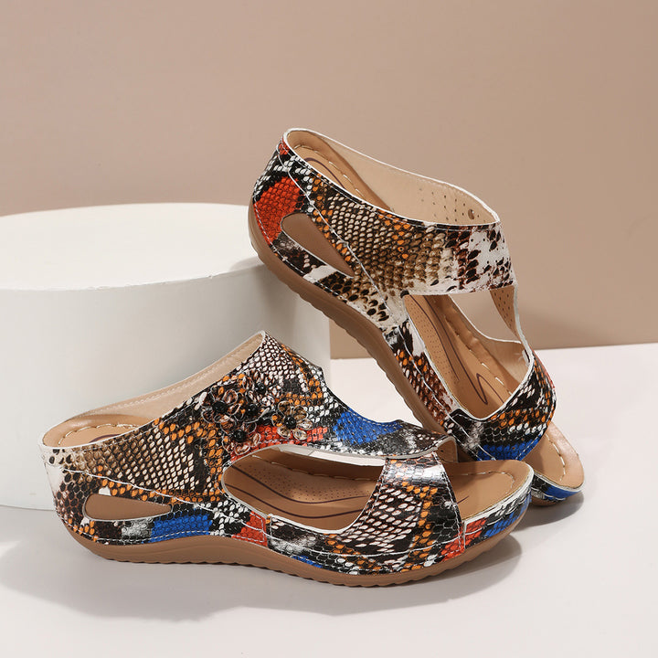Comfortable wedge sole sandals for women with an airy surface structure and elastic straps Lune London