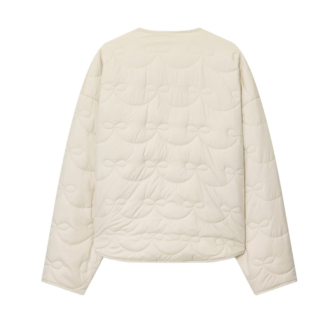 Women's short cut quilted jacket with round neckline and tonal bow quilting Amarae