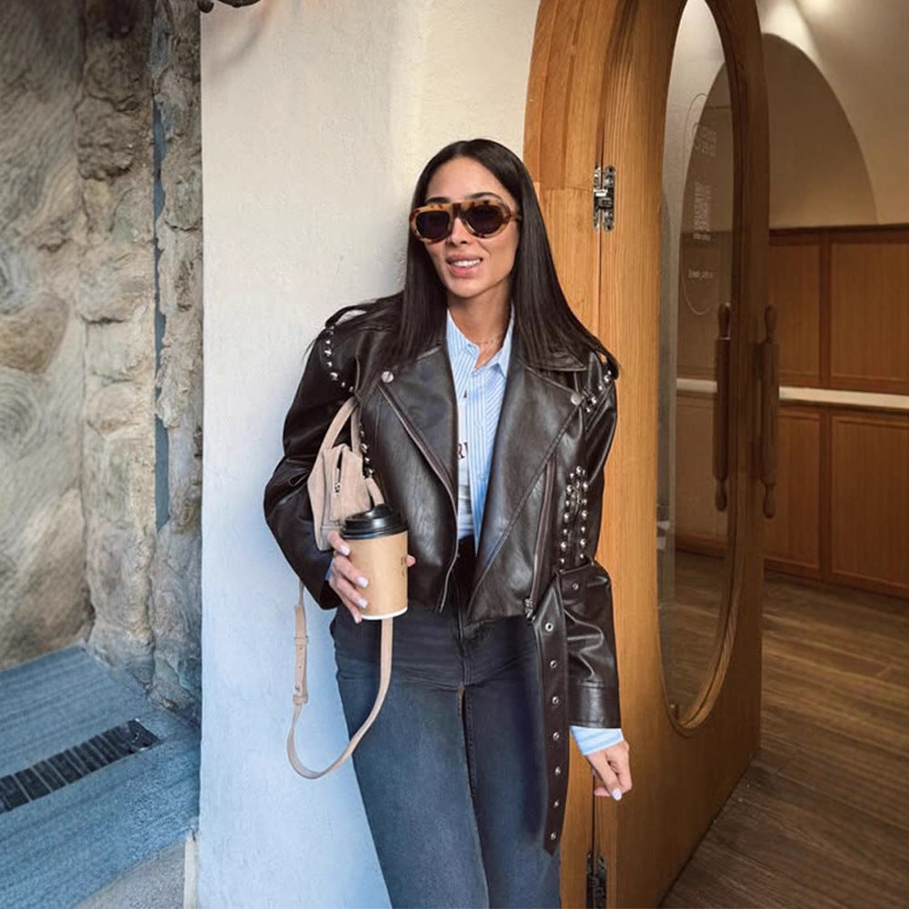 Women's Short Studded Biker Jacket Made of Faux Leather with Waist Belt Amarae