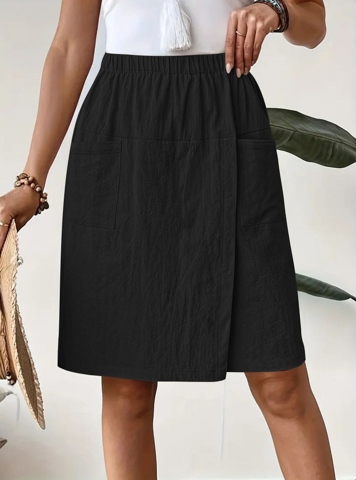Mid-length wrap skirt for women with elastic waist and practical pockets Lune London