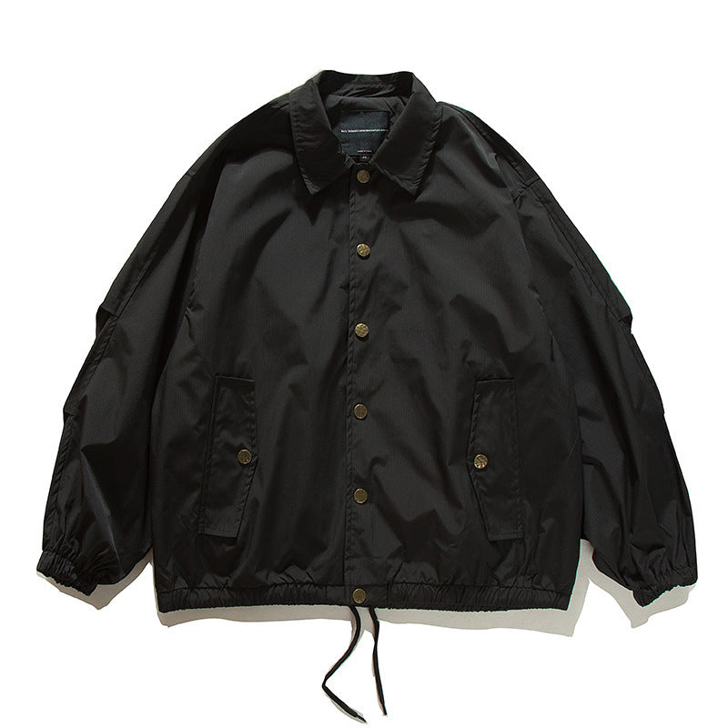 Unisex Boxy transitional bomber jacket with drawstring hem and snap button placket Amarae