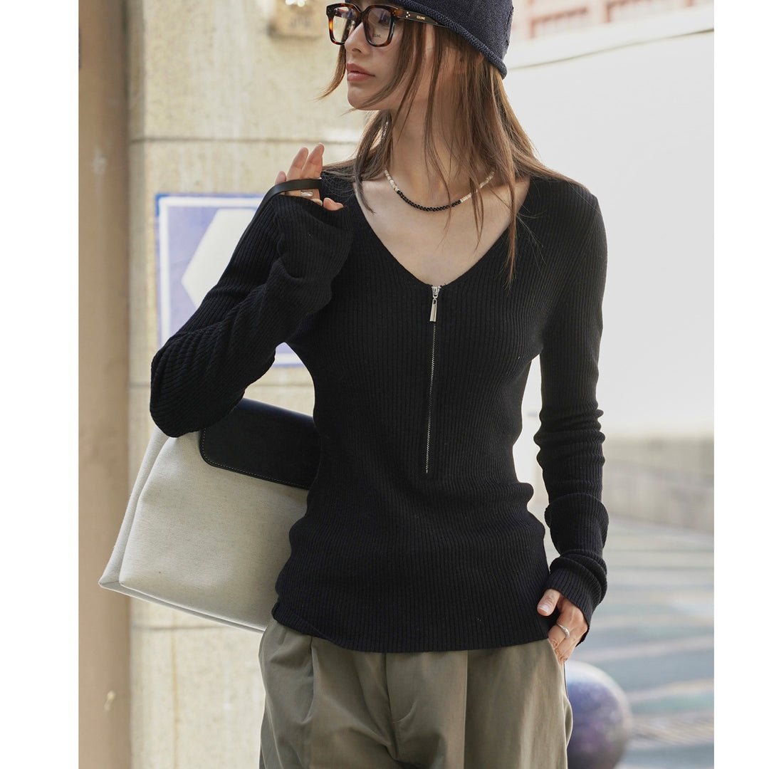 Women's fitted ribbed top with visible zipper at the back