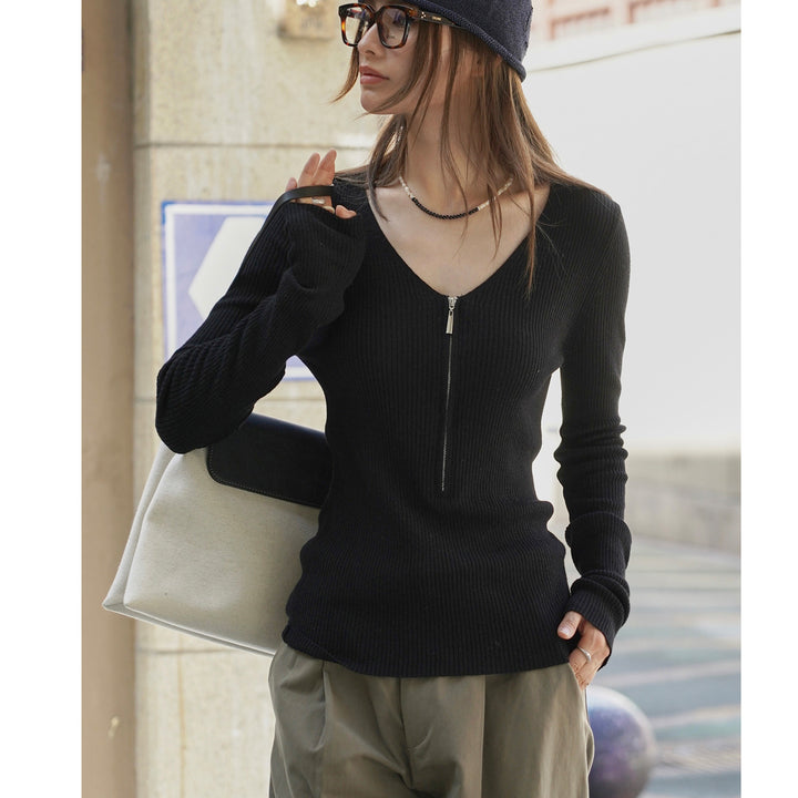Women's fitted ribbed top with visible zipper at the back