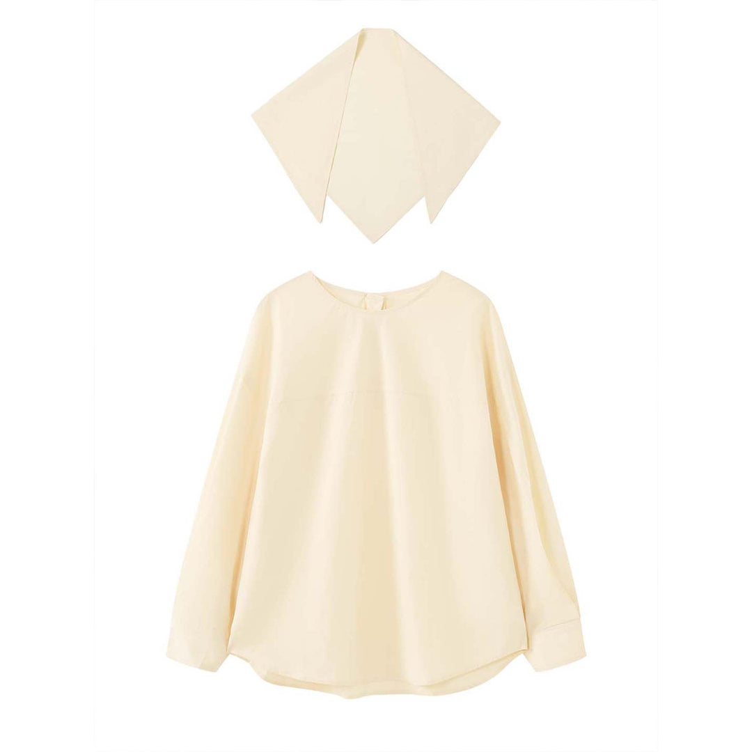 Women loosely cut cotton blouse with wrapped shawl collar and wide cuffs