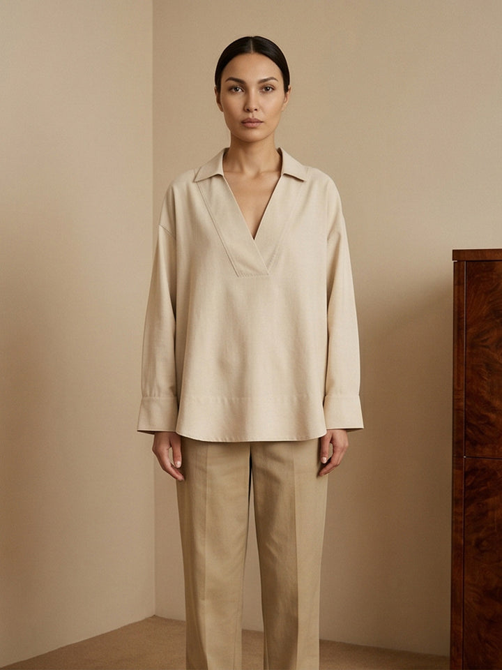 Women's loose-fitting tunic blouse with V-neck, shirt collar, and extended back hem Amarae