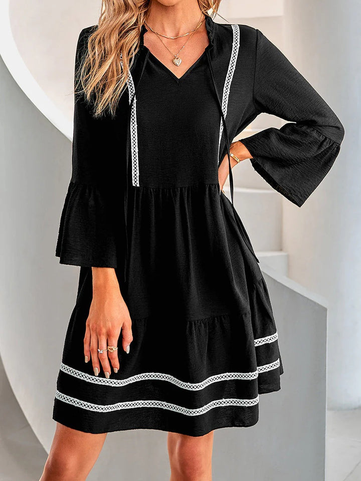 Casual mini dress for women with V-neck, decorative sleeve cuffs and playful hem Lune London
