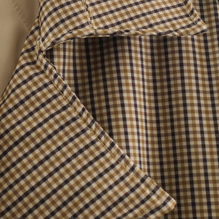 Women's short trench coat in checkered pattern with waist belt, shoulder straps and quilted inner lining Amarae