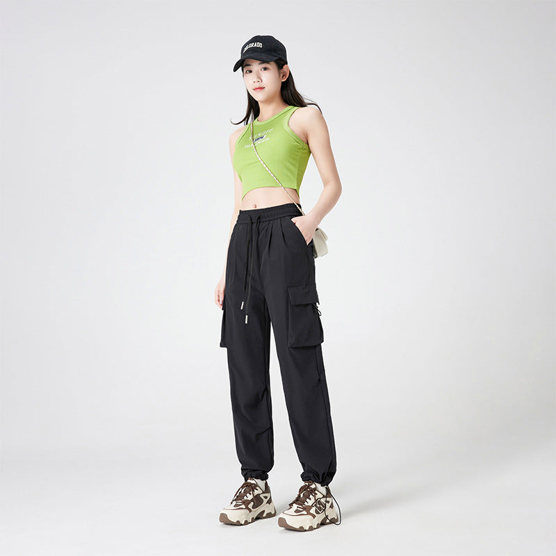 Women’s cargo pants in outdoor style with drawstring waistband, large side pockets, and adjustable hem.