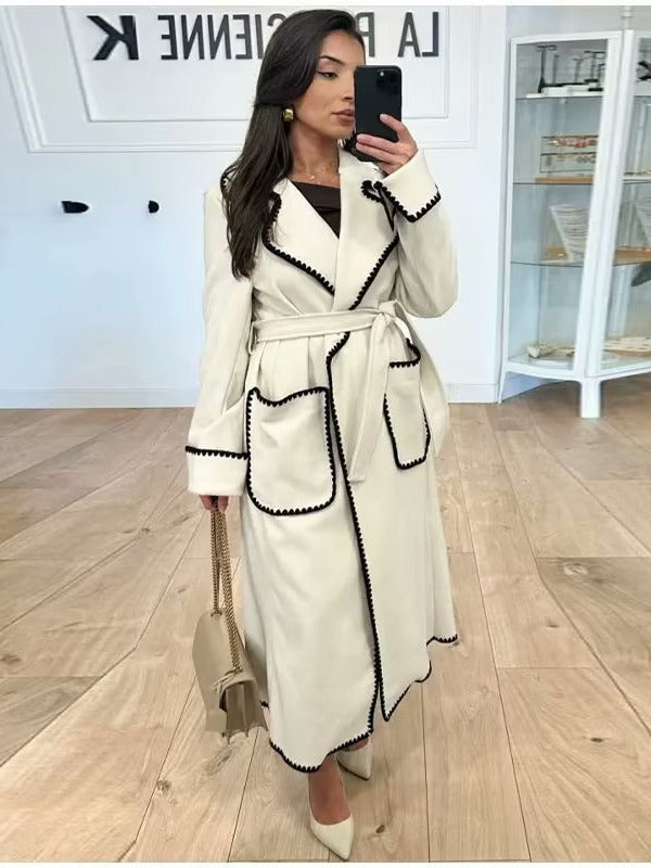 Elegant long coat for women with a tie belt and contrasting piping Lune London