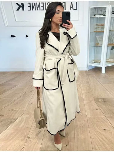 Elegant long coat for women with a tie belt and contrasting piping Amarae